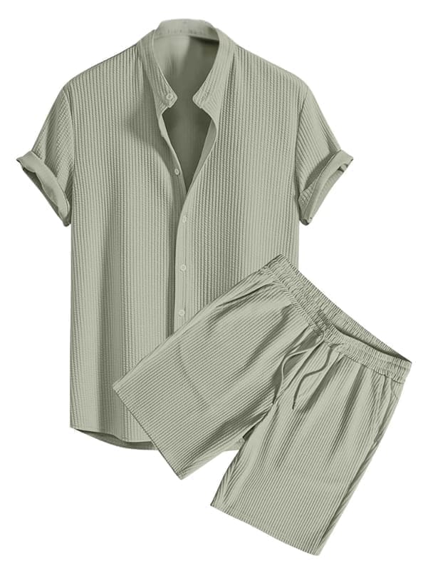GRECIILOOKS Men's Two-Piece Outfit shown as a matched set — textured button-down shirt with rolled-up sleeves and matching elastic-waist drawstring shorts in the same fabric and dye lot