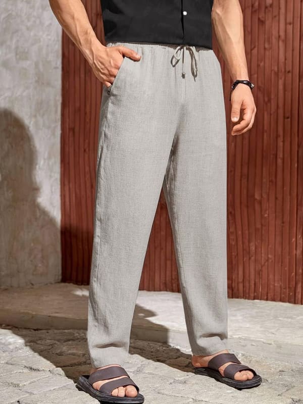 TOPLOT men's linen-blend pants in cream worn by model, front view showing elastic waist with drawstring and relaxed straight-leg drape
